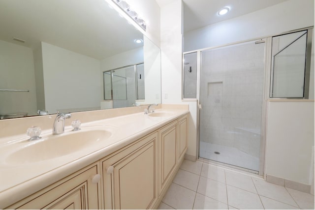 bathroom with tile patterned flooring, vanity, and an enclosed shower