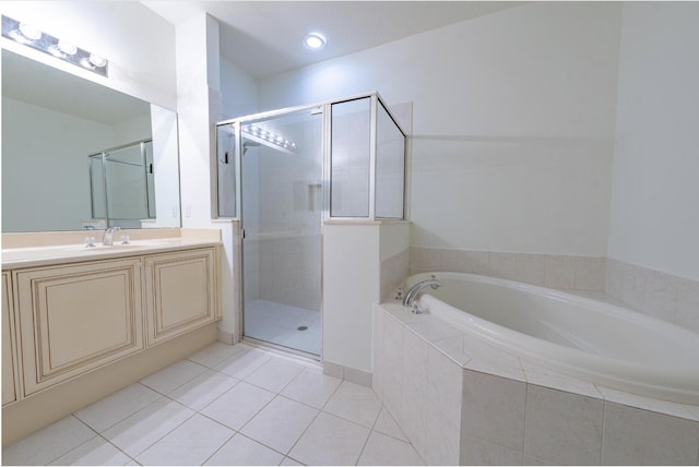 bathroom featuring tile patterned flooring, vanity, and shower with separate bathtub