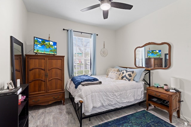 bedroom with ceiling fan and light hardwood / wood-style floors