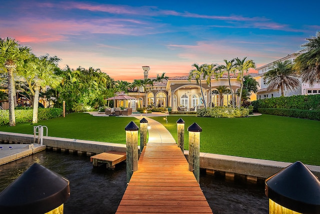 view of dock with a gazebo and a yard