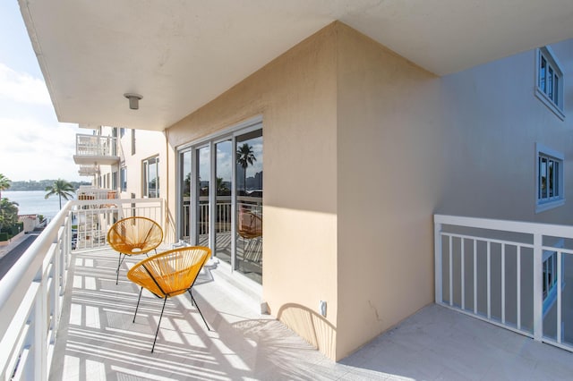 balcony featuring a water view