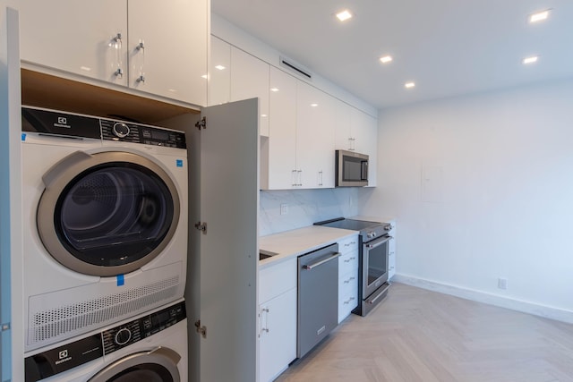 laundry area with stacked washer and dryer and light parquet flooring