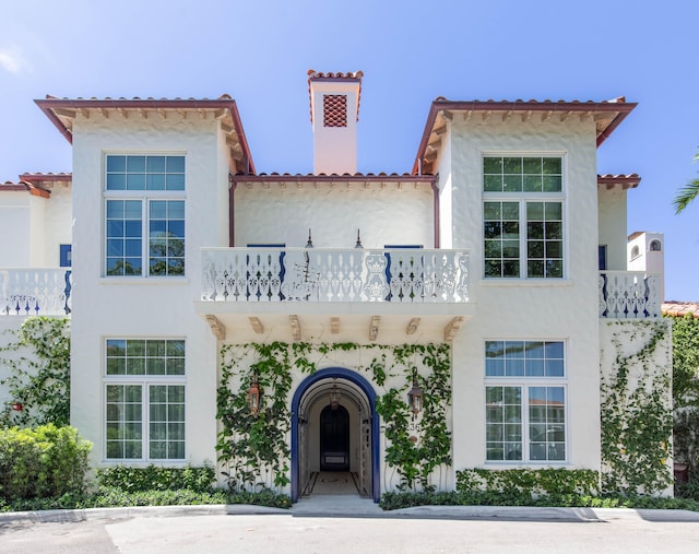 mediterranean / spanish house featuring a balcony