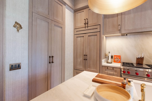 kitchen with light brown cabinets and stainless steel stove