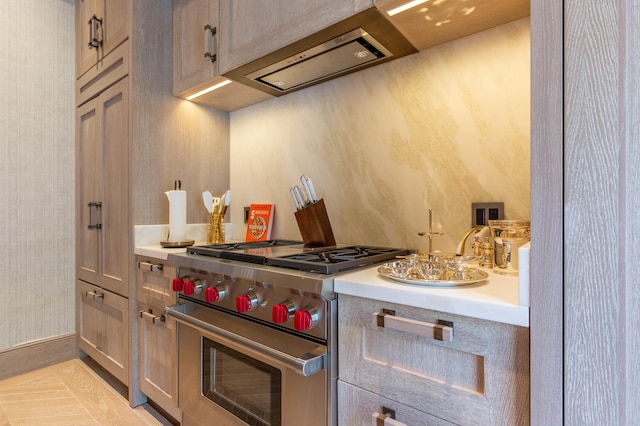 kitchen with high end stove, range hood, and light tile patterned floors