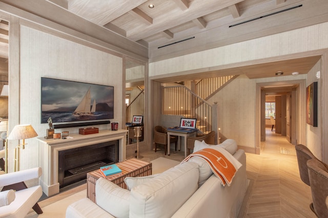 living room featuring beamed ceiling, light parquet floors, and coffered ceiling