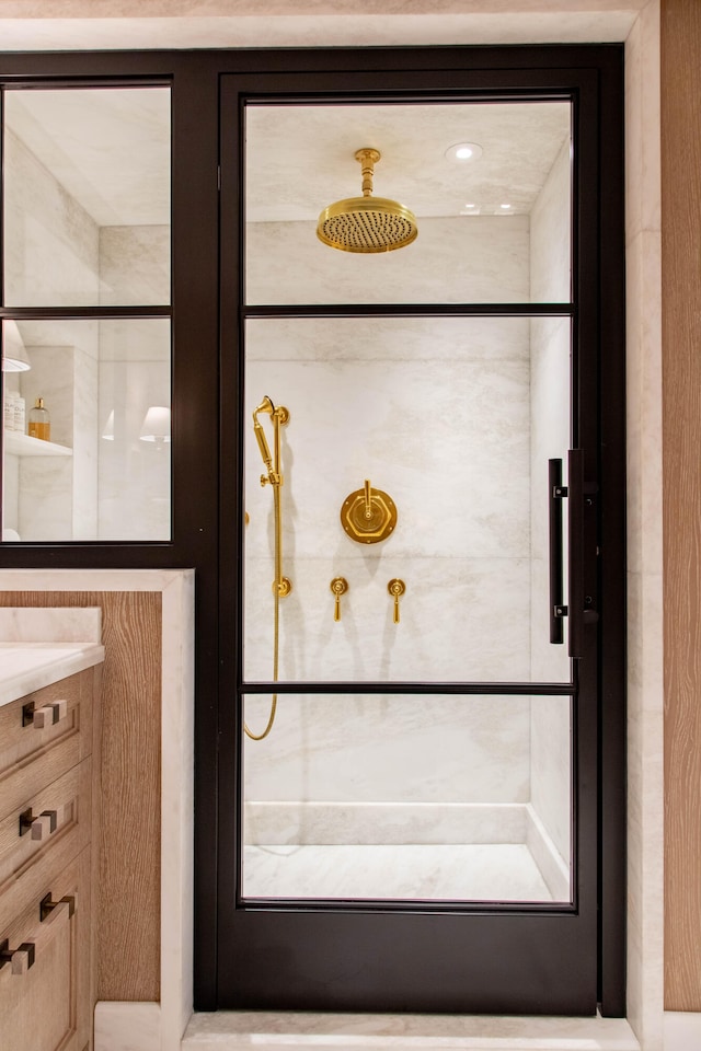 interior details featuring tiled shower