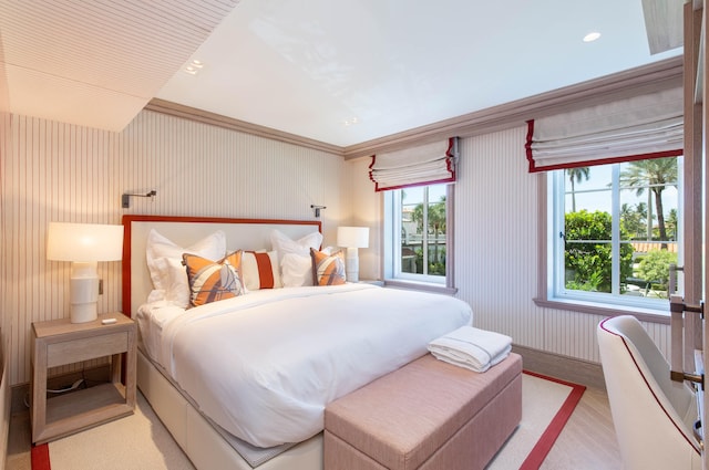 bedroom featuring multiple windows and crown molding