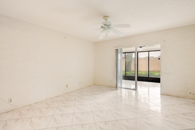 empty room featuring a textured ceiling and ceiling fan