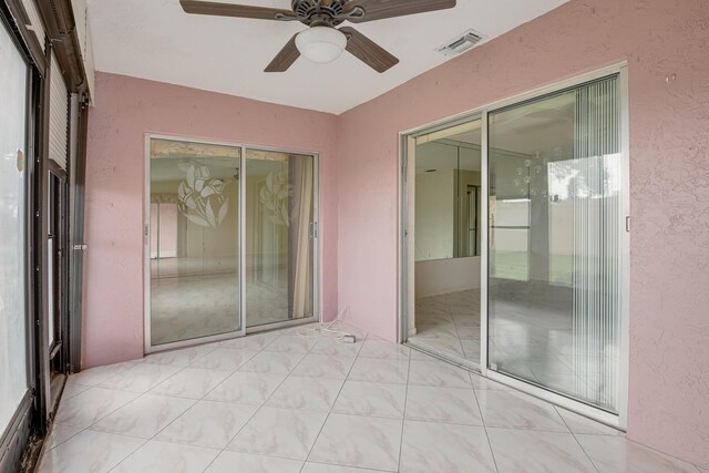 interior space with ceiling fan