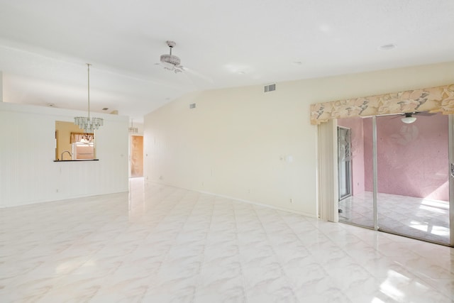 unfurnished room featuring vaulted ceiling and ceiling fan with notable chandelier