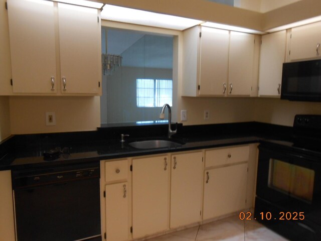 kitchen featuring white cabinetry, dishwasher, sink, a chandelier, and hanging light fixtures