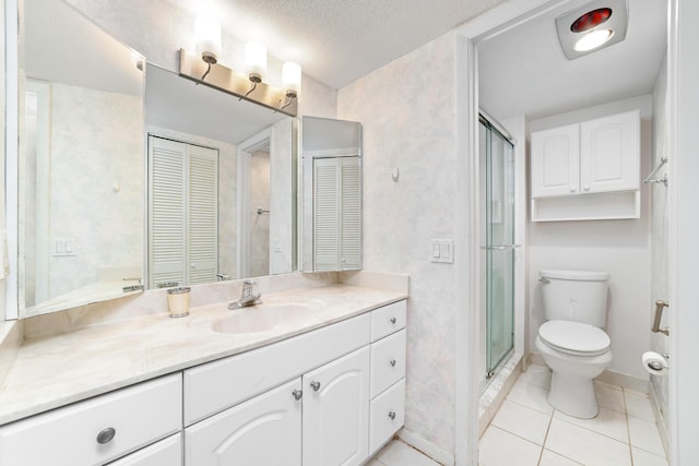 bathroom with vanity, walk in shower, toilet, tile patterned floors, and a textured ceiling