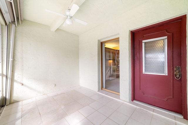 view of exterior entry with ceiling fan