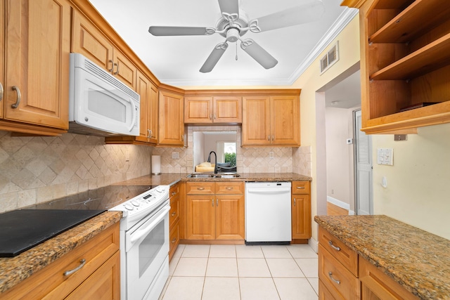 kitchen featuring sink, crown molding, light tile patterned floors, stone counters, and white appliances