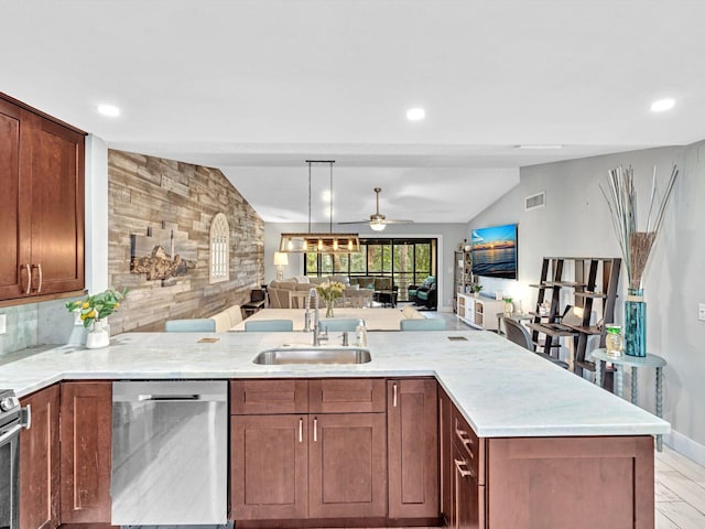 kitchen featuring light wood-type flooring, vaulted ceiling, dishwasher, sink, and light stone counters