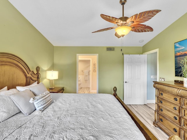 bedroom with ensuite bathroom, light wood-type flooring, and ceiling fan