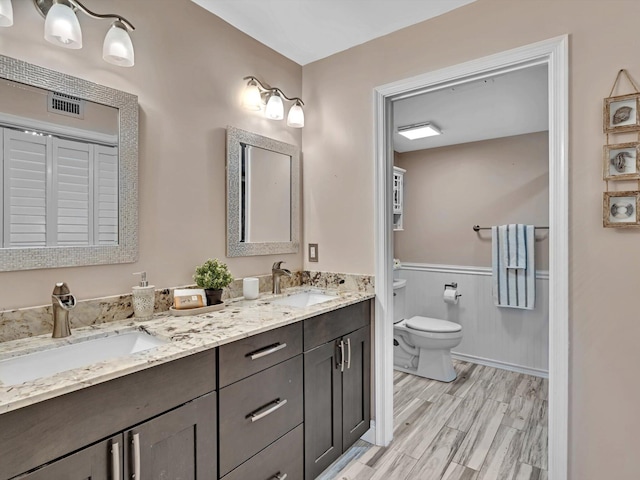 bathroom featuring vanity, toilet, and wood-type flooring