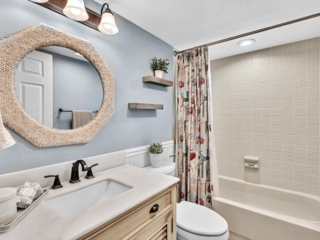 full bathroom with vanity, shower / bath combo with shower curtain, and toilet