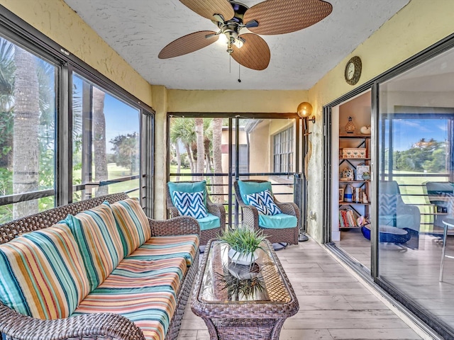 sunroom / solarium featuring ceiling fan