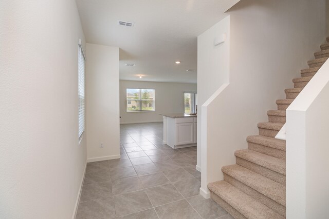 stairway featuring tile patterned flooring