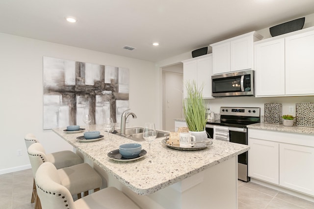 kitchen featuring white cabinetry, stainless steel appliances, and sink