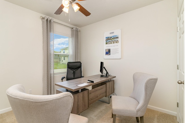 office area featuring light carpet and ceiling fan