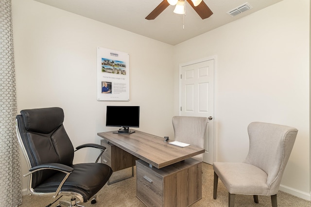 carpeted home office featuring ceiling fan