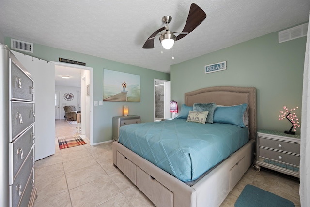 tiled bedroom with a textured ceiling and ceiling fan