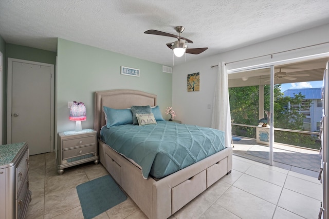 tiled bedroom featuring a textured ceiling, access to exterior, and ceiling fan