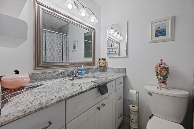 bathroom with vanity, toilet, and curtained shower