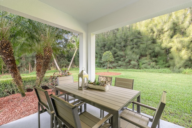 sunroom with a yard and a patio area