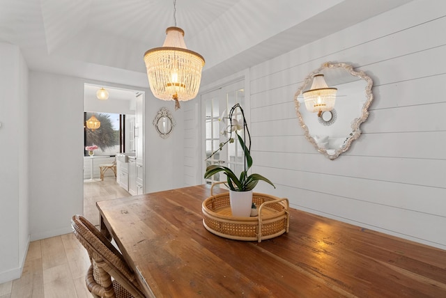 dining area featuring a chandelier and light wood-type flooring