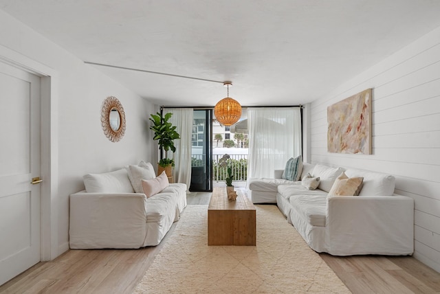 living room featuring floor to ceiling windows and light hardwood / wood-style flooring