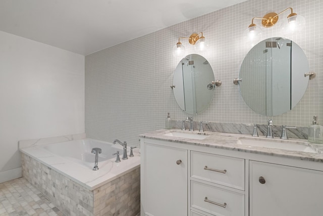 bathroom with tile patterned floors, vanity, tile walls, and tiled bath