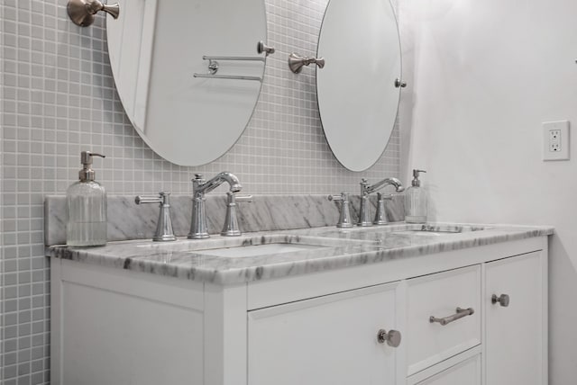 bathroom with decorative backsplash and vanity