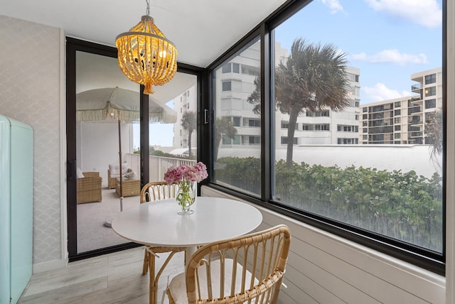 sunroom featuring a notable chandelier and plenty of natural light