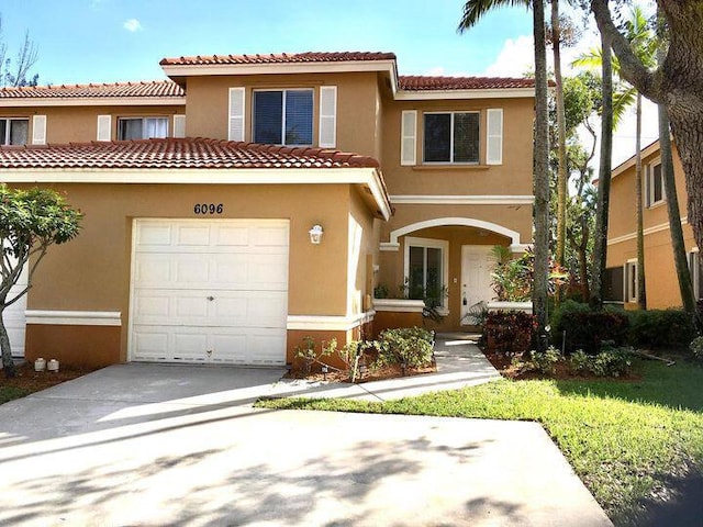 mediterranean / spanish-style home featuring a garage