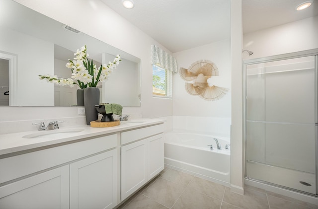 bathroom with tile patterned flooring, shower with separate bathtub, and vanity