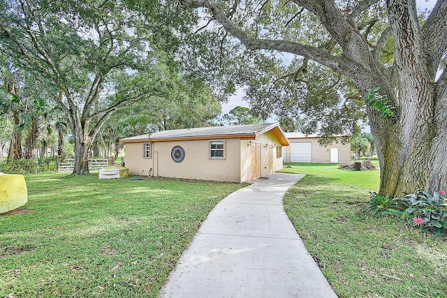 view of front of property with a garage and a front yard