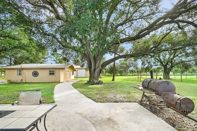 view of yard featuring a patio and a garage