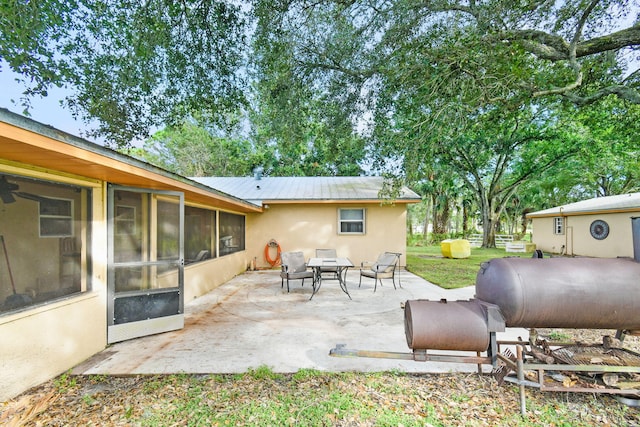 view of patio featuring a sunroom