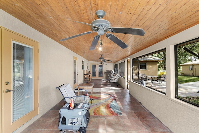 sunroom with wood ceiling and ceiling fan