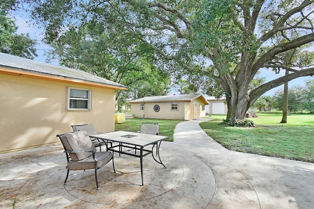 view of patio / terrace with a garage and an outdoor structure