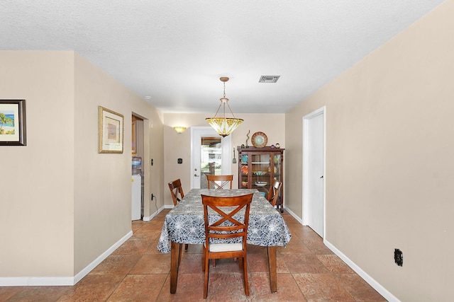 dining room featuring a textured ceiling