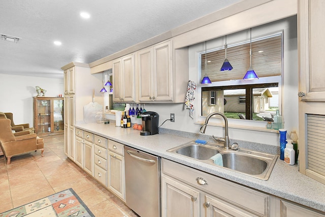 kitchen with dishwasher, a textured ceiling, sink, light tile patterned floors, and pendant lighting