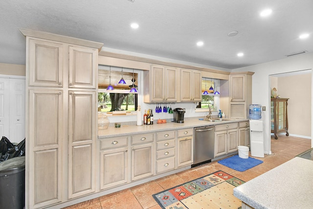 kitchen with dishwasher, sink, and light tile patterned floors