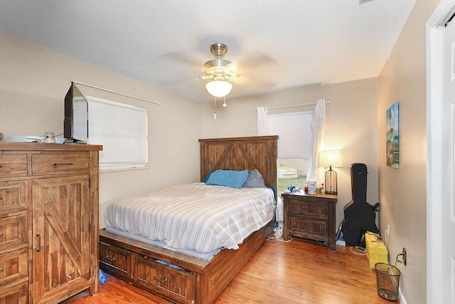 bedroom with ceiling fan and light hardwood / wood-style flooring