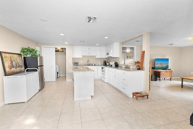 kitchen featuring a textured ceiling, white appliances, sink, and white cabinets