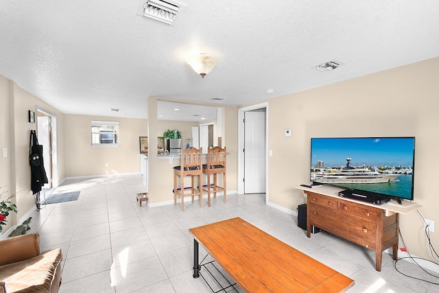 tiled living room with a textured ceiling